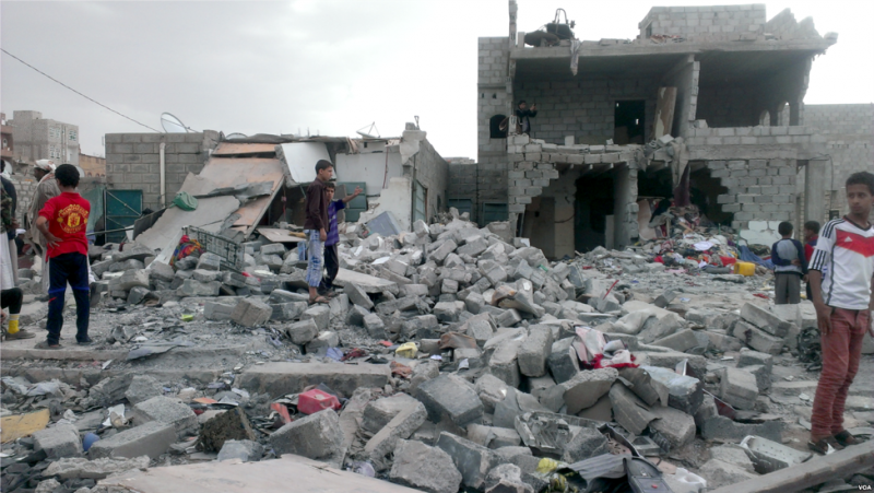 Yemeni survivors looking for valuables amongst rubble from destroyed building in a Yemeni Neighborhood, taken by Almigdad Mojalli from Voice of America, found at http://gdb.voanews.com/0EE625A0-68D1-46E0-8628-AE3CE6B70E68_mw1866_mh799_s.png, Public Domain