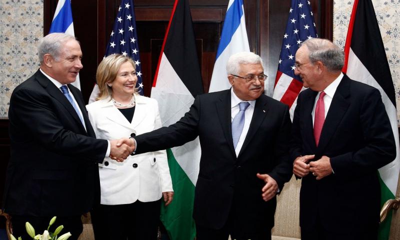 Israeli Prime Minister Benjamin Netanyahu shakes hands with Palestinian President Mahmoud Abbas.