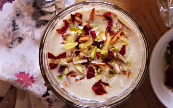 a cup of talbina topped with honey and nuts.