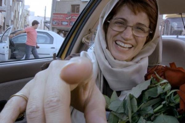 Image of a woman passanger pointing at the driver - from the driver's point of view