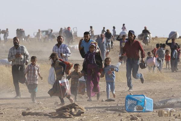 a scene from Arab Spring of families running in a desert 